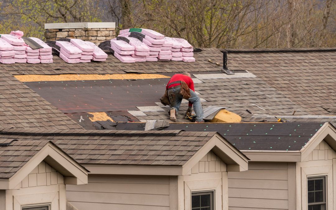 roofing contractor removing old shingles
